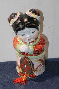lot 862 image: Ceramic Figurine of Child in Traditional Attire with Decorative Coins