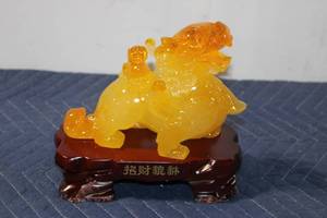 lot 1106 image: Yellow Chinese Pixiu Prosperity Figurine on Wood Base