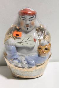 lot 679 image: Porcelain Figurine with Red Hat and Gold Details