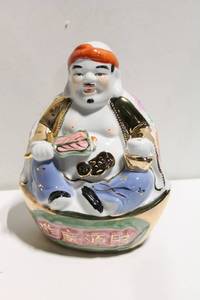lot 680 image: Hand-Painted Porcelain Figurine of Smiling Man with Gold Accents