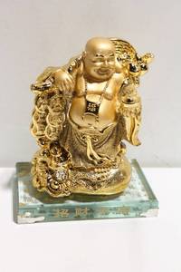 lot 967 image: Gold-Tone Laughing Buddha Figurine with Glass Base