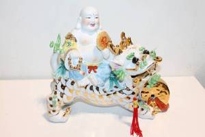lot 1200 image: Porcelain Laughing Buddha Riding Dragon Figurine with Gold Accents