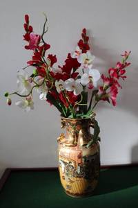 lot 7 image: Decorative Porcelain Vase with Intricate Designs and Artificial Floral Arrangement