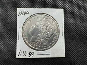 lot 11 image: 1886 Morgan Silver Dollar Marked AU-58 when purchased