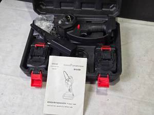 lot 238 image: Small Electric Chain Saw with Two Batteries and Instruction Manual