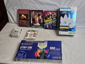 lot 326 image: Mixed Lot of Holiday Items - DVDs, Lights, Photo Camera, and Decorations