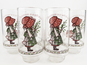 lot 36 image: HOLLY HOBBIE Set of 6 COCA-COLA Limited Edition Christmas Glasses Christmas is a gift of joy