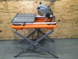 lot 13 image: Ridgid 9-Amp 7 Blade Corded Wet Tile Saw with Stand Model # R4031
