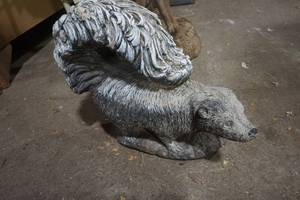 lot 92 image: skunk statue. cement.