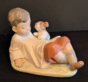 lot 24 image: Lladro Taking Time Porcelain Boy with Dog Figurine