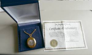 lot 50 image: Locket with a 120 oz silver coin, cuff links, tie clasps, watch, etc