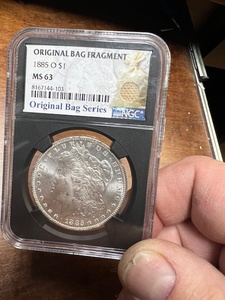 1885 O Morgan Silver Dollar MS 63 in a bag frag NGC collector slab