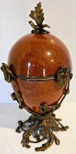 lot 31 image: Art Deco Style Red Glazed Ceramic EGG BOX with Decorative Brass Holder Stand