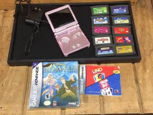 lot 153 image: Vintage Gameboy Advance SP with game cartridges - works