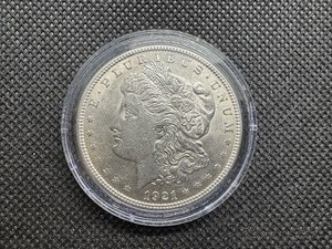 1921 Uncirculated Morgan Dollar. Strong Definition of Hair Above Ear and Breast Feathers, Bagmarks Typical of MS62
