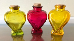 lot 123 image: Three Heart Motif Glass Bottles