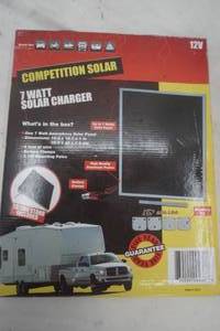 lot 103 image: Solar Panel Lot includes 7 watt solar panel, 6 ft of wire, battery clamps, 2 tilt mounting poles
