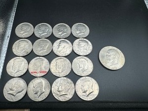Sixteen Bicentennial Half Dollars and One Bicentennial Ike Dollar