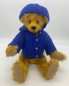 lot 128 image: Vintage Mohair Teddy Bear with a Hand Knit Royal Blue Sweater and Hat