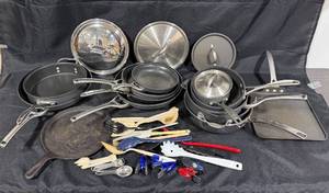 lot 295 image: Assorted Cookware Set including Calphalon Skillets, Cooking Utensils, and Baking Sheet