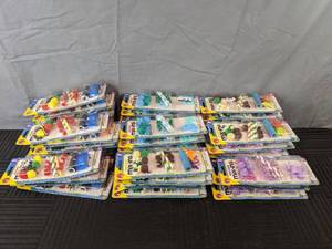 lot 158 image: 43 Packages of Sensory Bin Mix-Ins - Racing, Mermaid, Dinosaurs, and Unicorn Themes