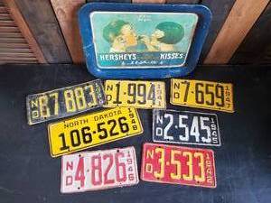 lot 74 image: Super Cool Collection of 1940s North Dakota License Plates and Hershey Tray