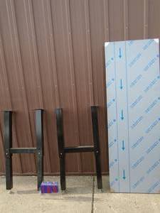 lot 100 image: Stainless table top table approx 24 x 60 Needs hardware & assembly. Very heavy bring help to load. As shown.