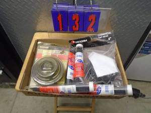 lot 132 image: Flat of Kawasaki trimmer heads & other misc trimmer parts. As shown.