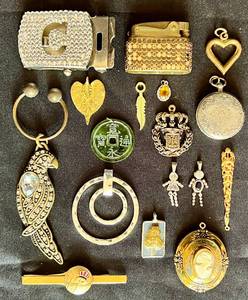 Collection of Assorted Jewelry Pieces- Pendants and Slides, Belt Buckle, Lighter, Keychain, Tie Clips