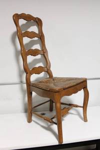 lot 100 image: Vintage Wooden Chair with Intricate Carvings and Woven Seat
