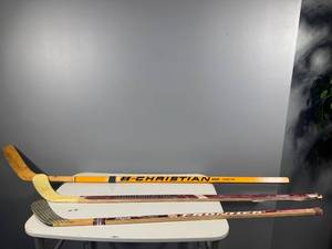 lot 49 image: Collection of 3 Vintage Hockey Sticks - Christian Bros, Minnesota Wild, Frontier