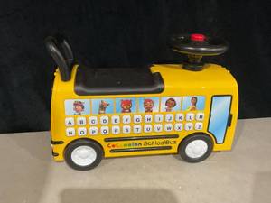lot 412 image: CoComelon School Bus Ride-on with Letters, Numbers, & Music