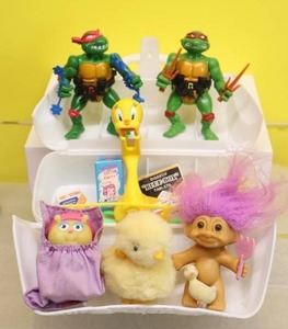 lot 55 image: Vintage Doctors Kit wMiniatures, Tmnt Raphael Breakfighting Weapon C Ninja Turtles, Tweety Toothbrush Holder, Easter Troll & Fuzzy Duckling Etc
