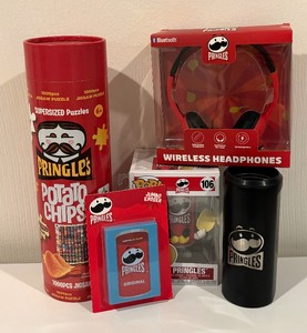 lot 344 image: Pringles Motif Jigsaw Puzzle, Wireless Headphones, Figurine, Charger Box and More