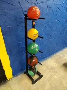 lot 25 image: Weighted balls with storage rack CAP 2LB, 4LB, 8LB kinesi-o-balls, Nike 8LB, and TKO 6LB