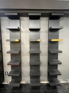 lot 62 image: (3) black wall-mounted display shelving units