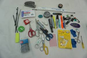 lot 168 image: Office Supply Lot pocket knife, American Flag sticker, notecards, pens, Sharpies, paper clips, stapler, super glue, pocket tape measure, clips, scissors, ruler