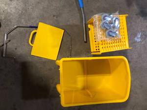 lot 44 image: Mind Reader 5.5 Gal. Yellow Plastic Mop Bucket with Wringer Floor Cleaning, Handle, Wheels, 16.25 in. L x 10.75 in. W x 24.5 in. H   Customer Returns See Pictures