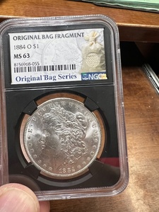 lot 9 image: 1884 O Morgan Silver Dollar, MS 63 NGC graded, Bag Frag.