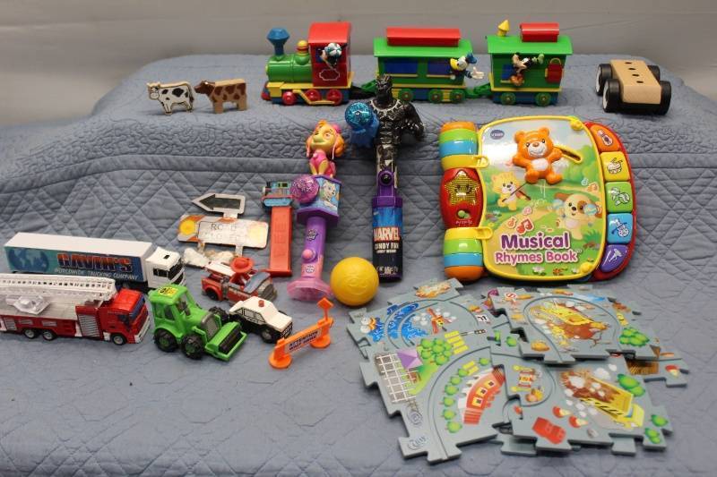 lot N-184 image: Assorted Kids Toys Including Musical Rhymes Book, Trains, and Action Figures