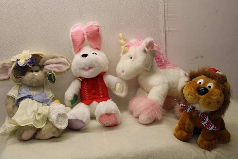 lot 571 image: Collection of 4 Stuffed Animals Lion, Bunny, Unicorn, and Vintage Rabbit