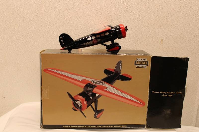 lot 612 image: Vintage Harley Davidson Lockheed Vega 56 Die Cast Metal Airplane Bank