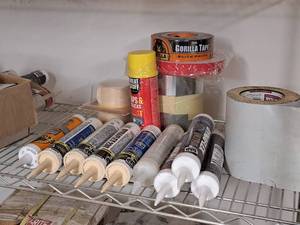 lot 104 image: Assorted Flashing, Tapes and Sealants - Dap Dynaflex, Gorilla Construction Adhesive, Black Gorilla Tape, Crack Fill,  Band-It Real Wood Veneer Edging White Birch