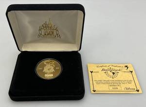lot 118 image: Disney 50 Year Adventureland Collectors Coin  No. 0328 With COV (NIB)