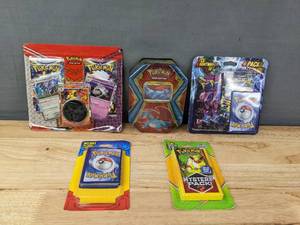 lot 27 image: 5 Brand New Pokemon Trading Card Packs Salamence Tin Box, TCG Lightning Set, Mystery Pack and More I