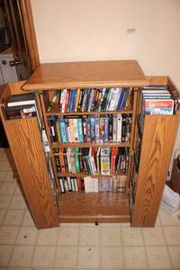 lot 450 image: Oak DVDVHS Media Storage Tower with 80 Movies and Series Collection