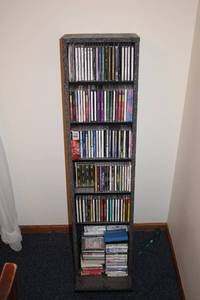 lot 470 image: Collection of 40 Music CDs and Cassette Tapes with Storage Rack