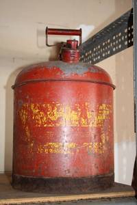lot 712 image: Vintage Red Fire Extinguisher with Yellow Label