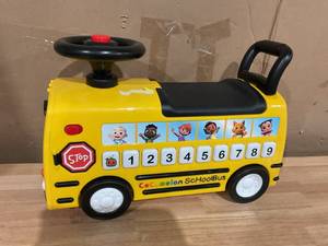 lot 602 image: CoComelon School Bus Ride-on with Letters, Numbers, & Music