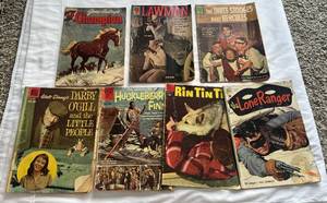 lot 88 image: (7) Vintage Comic Books by Dell 10 and 15 Cent Walt Disney, Huckleberry Fin, Rin Tin Tin, Lone Ranger, Champion, Lawman, Three Stooges 1951-1962
